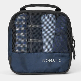 NOMATIC small Compression Packing Cube in navy, mesh top showing packed clothing