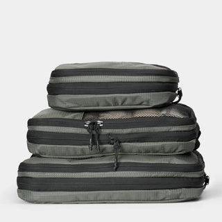 nomatic.mompression Packing Cubes in moss, compressed and stacked, top view