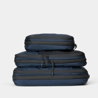 nomatic.mompression Packing Cubes in navy, compressed and stacked, top view
