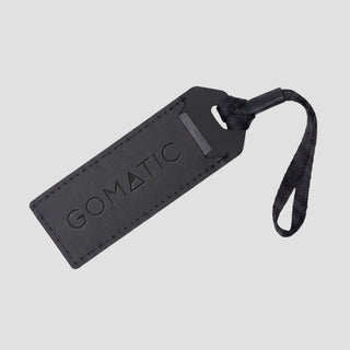 NOMATIC Luggage Tag, Gomatic branded, in black, front angled view