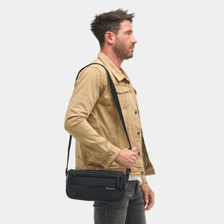 NOMATIC Luma Camera Sling 9L in black, worn cross-body by model, side view