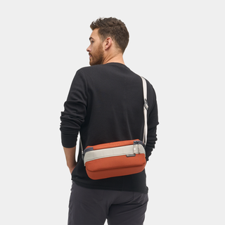NOMATIC Luma Camera Sling 9L in rust, worn cross-body by model, back view