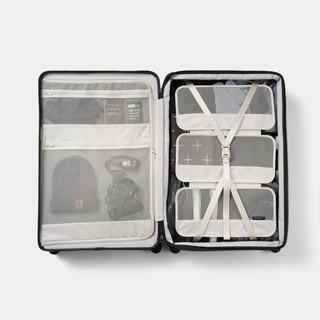 Inside look of the Method Check-In Luggage showing the compression strap in use.