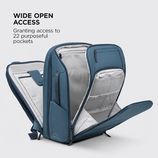 A blue-gray laptop backpack shown open to reveal its interior compartments and pockets, with text on the left reading 'WIDE OPEN ACCESS' and 'Granting access to 22 purposeful pockets.'.